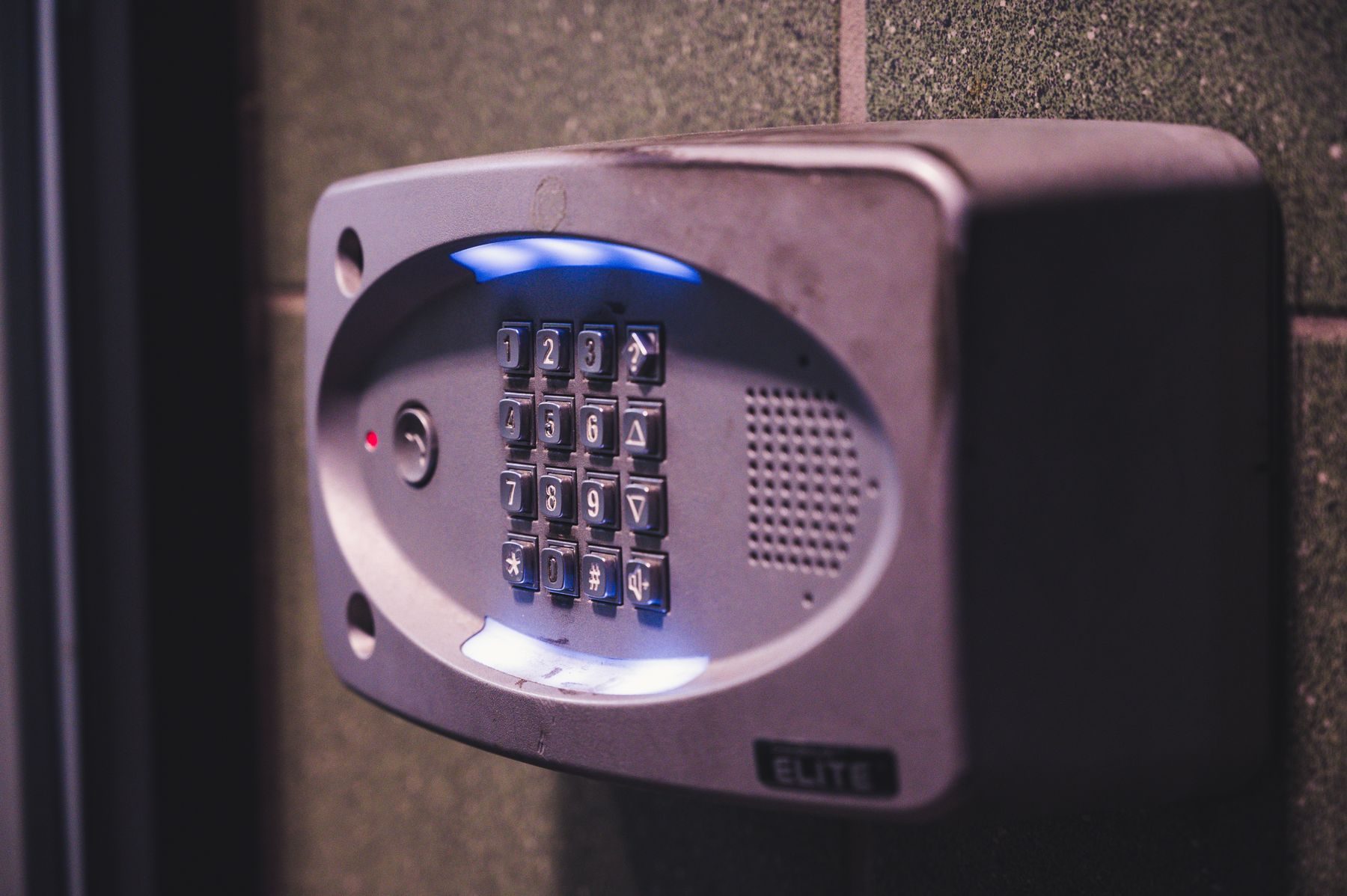 Illuminated keypad access control mounted on a wall